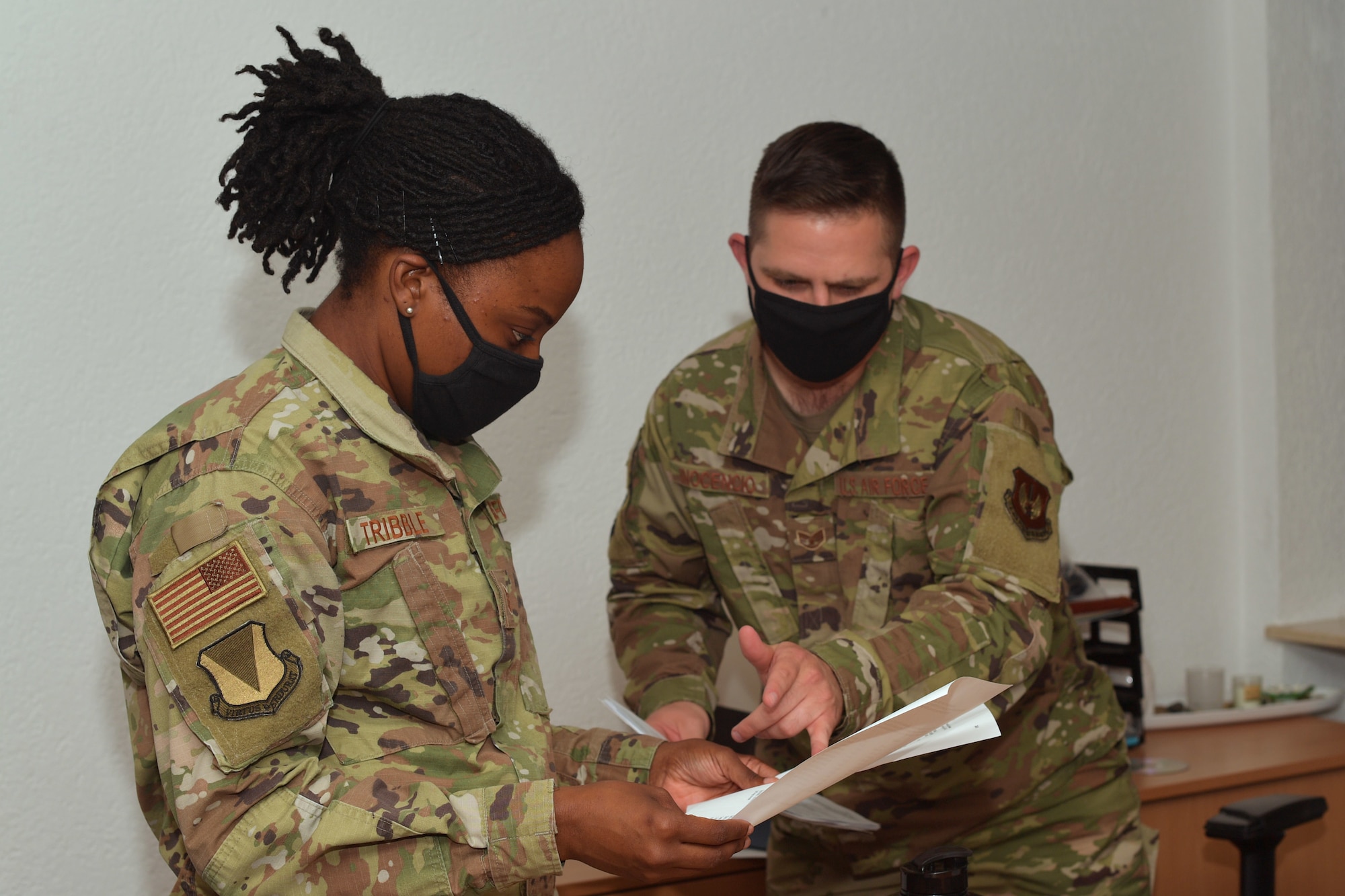 Two Airmen looking at a document.