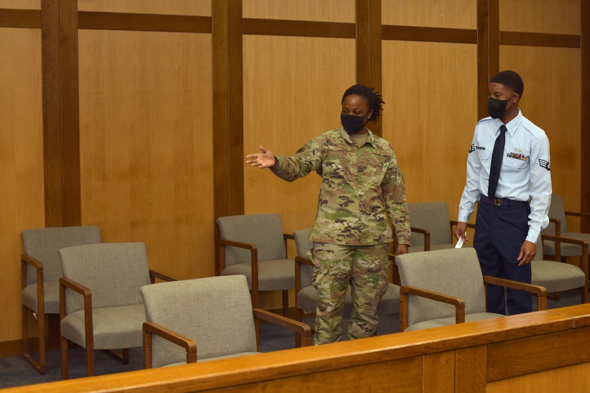 Two Airmen standing in a court room.