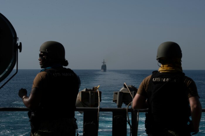 200915-N-DQ752-1100 STRAIT OF HORMUZ (Sept. 18, 2020) Sailors man a .50-caliber machine gun mount on the flight deck of the aircraft carrier USS Nimitz (CVN 68) during a Strait of Hormuz transit, Sept. 18. Nimitz Carrier Strike Group is deployed to the U.S. 5th Fleet area of operations in support of naval operations to ensure maritime stability and security in the Central Region, connecting the Mediterranean and the Pacific through the western Indian Ocean and three strategic choke points. With Nimitz as the flagship, deployed strike group assets include staffs, ships and aircraft of Carrier Strike Group 11, Destroyer Squadron 9, USS Princeton (CG 59) and Carrier Air Wing 17.  (U.S. Navy photo by Mass Communication Specialist 3rd Class Cheyenne Geletka)