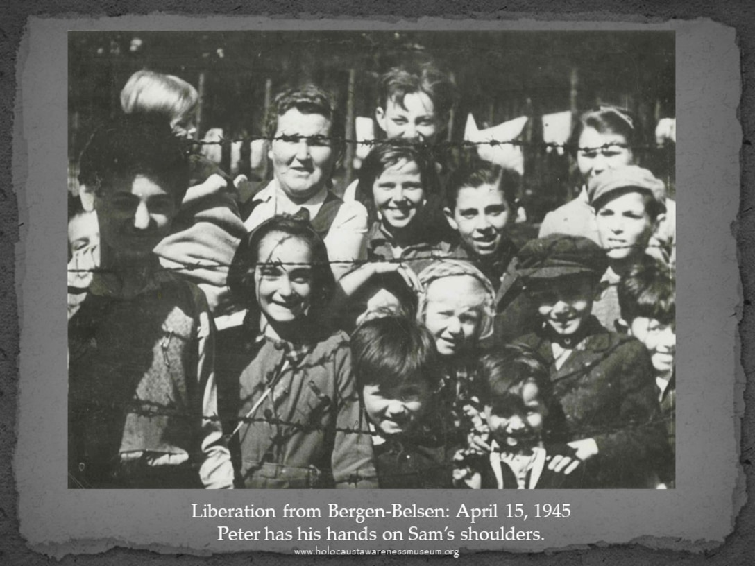 Peter Stern, lower right with his hands on his brothers shoulders, and other survivors are liberated from the Bergen-Belsen concentration camp, Germany, April 15, 1945. Stern told his families story during the DLA Troop Support's virtual Holocaust observance program September, 16.
