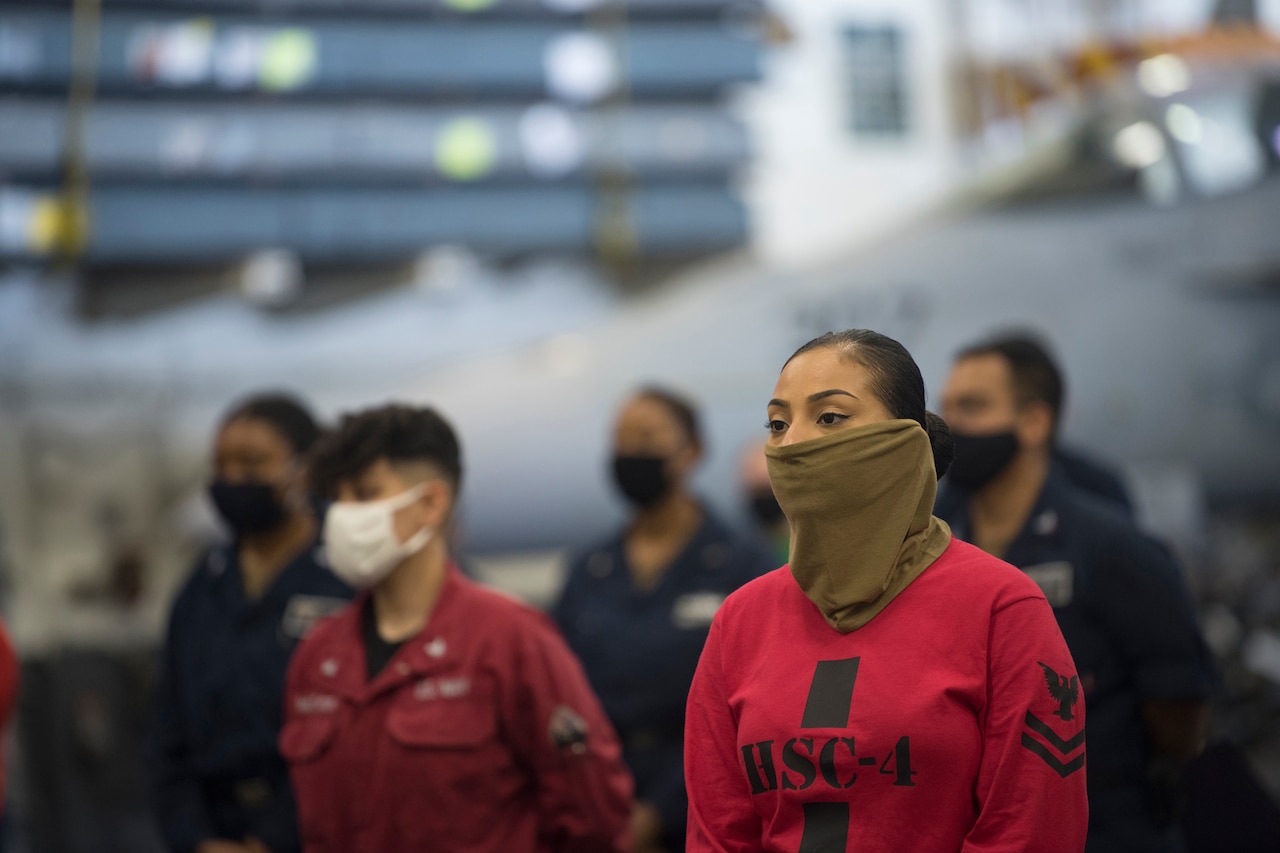 Sailors listen to speaker.