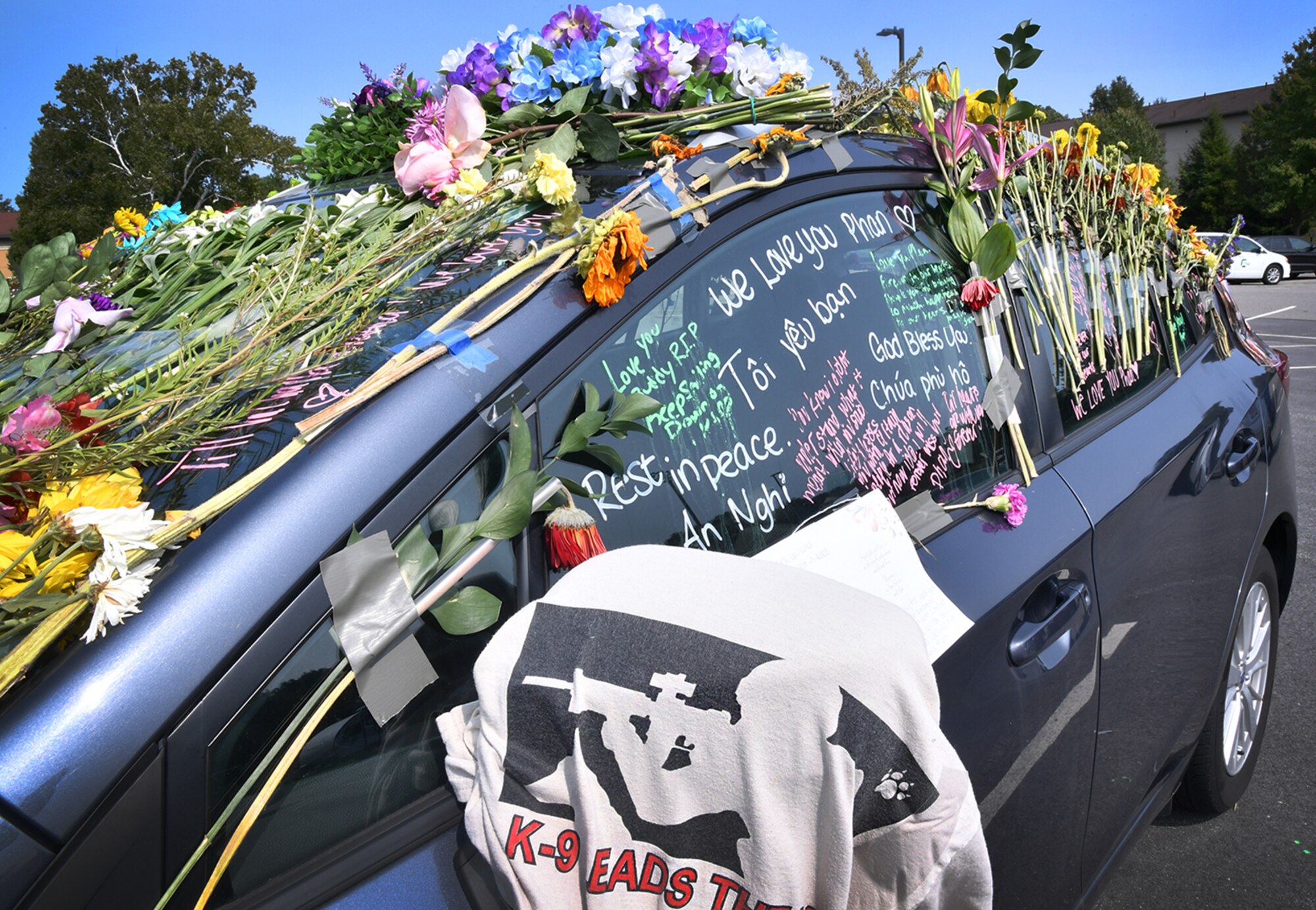 Flowers and messages cover Senior Airman Jason Phan’s vehicle in the long-term parking lot at Hanscom Air Force Base, Mass., Sept. 16. Phan, a 66th Security Forces Squadron entry controller, was killed in a non-combat related accident while serving overseas, Sept. 12. (U.S. Air Force photo by Linda LaBonte Britt)