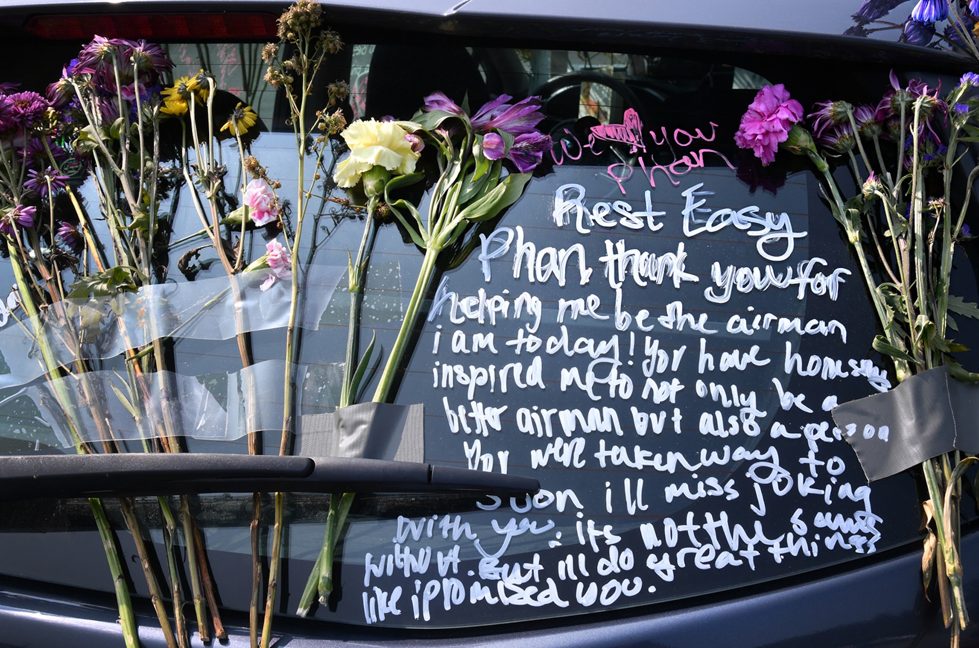 Flowers and messages cover Senior Airman Jason Phan’s vehicle in the long-term parking lot at Hanscom Air Force Base, Mass., Sept. 16. Phan, a 66th Security Forces Squadron entry controller, was killed in a non-combat related accident while serving overseas, Sept. 12. (U.S. Air Force photo by Linda LaBonte Britt)