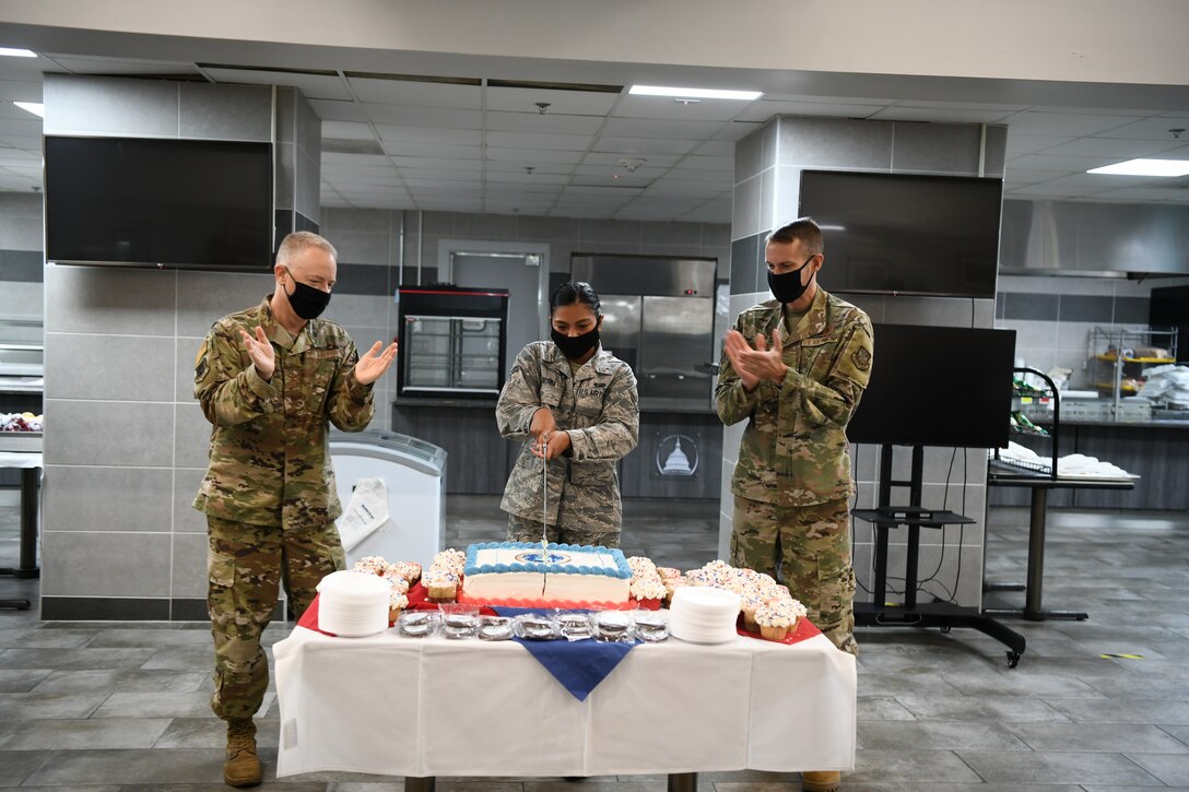 Airman 1st Class Leanne Mae Jayoma, 316th Force Support Squadron outbound assignment technician, cuts the Air Force Birthday cake at JBA, Md., Sept. 18, 2020. During a cake-cutting ceremony, the first piece of cake is given to the guest of honor. The second piece is given to the eldest Airmen, who then in turn passes it to the youngest Airmen, signifying the passing of knowledge from the old to the young of the Air Force. (U.S. Air Force photo by Airman 1st Class Spencer Slocum)