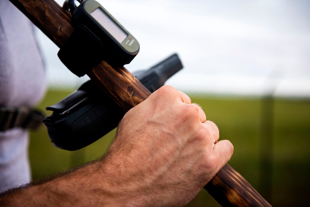 Photo of Airman holding the POW/MIA flag during a ruck march.