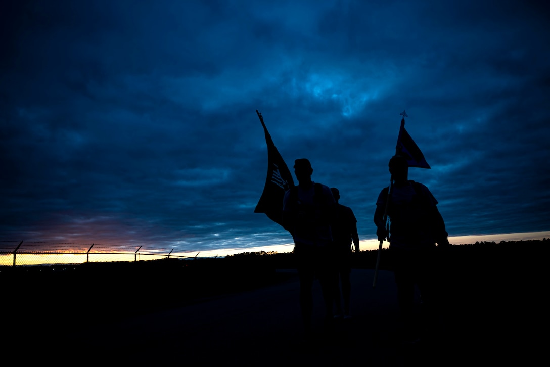Photo of Airmen participating in a ruck march.