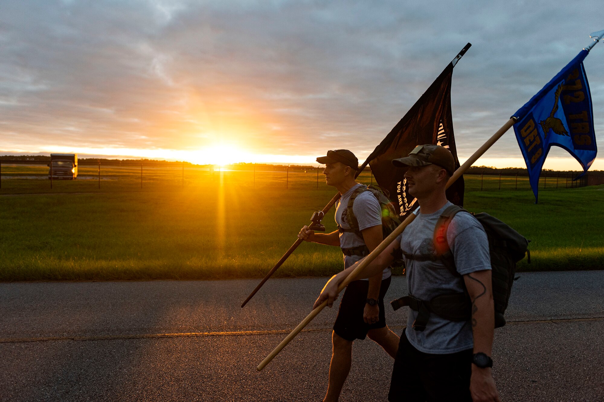 Photo of Airmen participating in a ruck march.