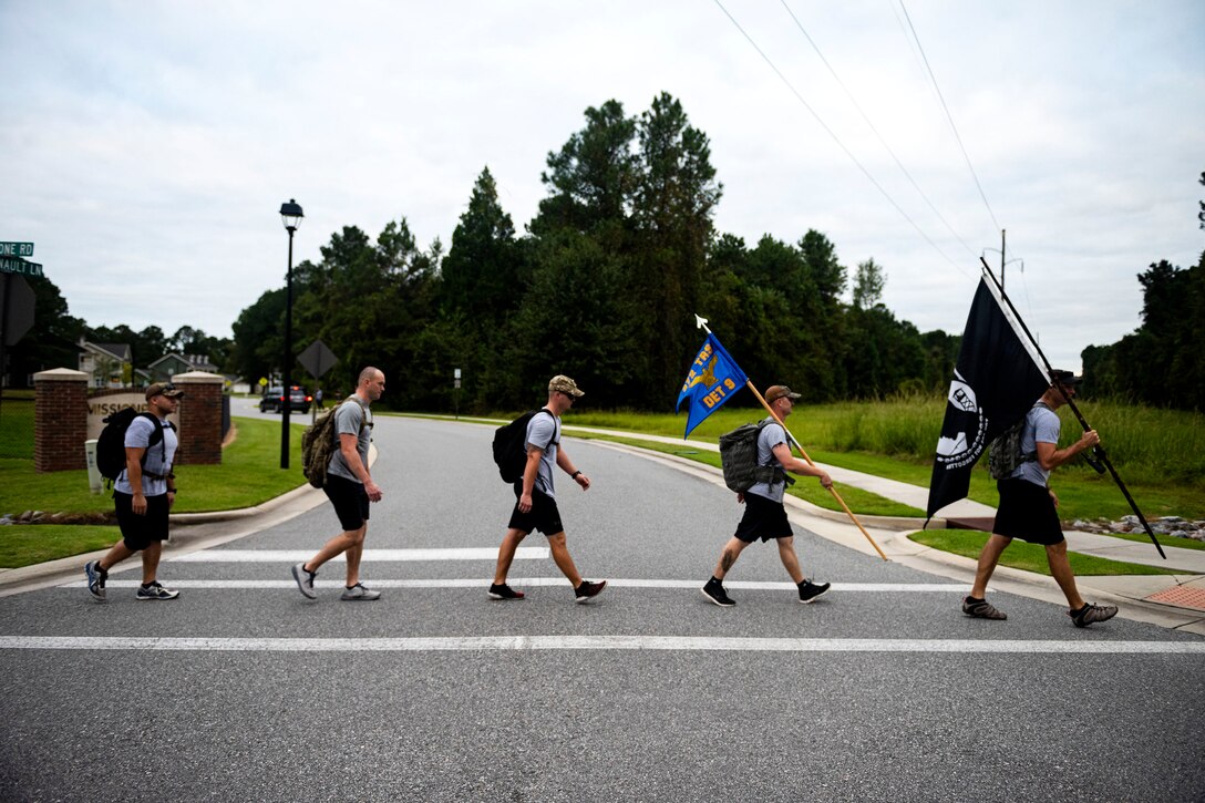 Photo of Airmen participating in a ruck march.