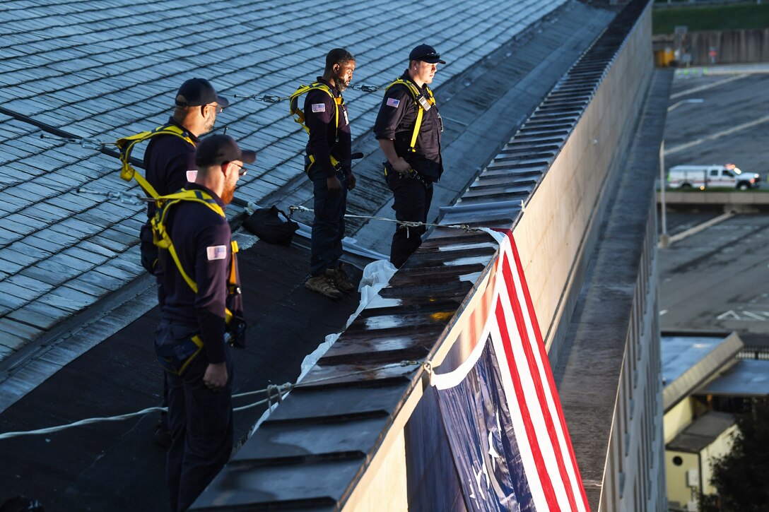 Men stand on the rooftop of the Pentagon.