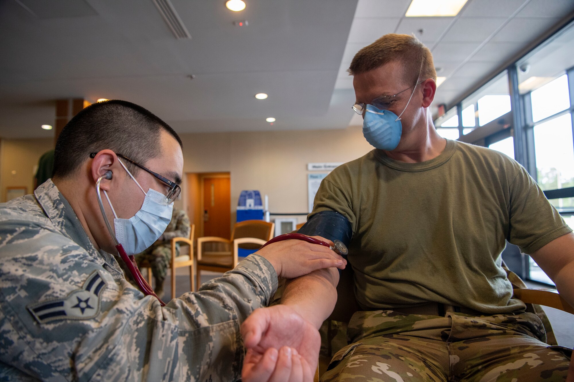 An Airman checks on a patient in the medical facility.