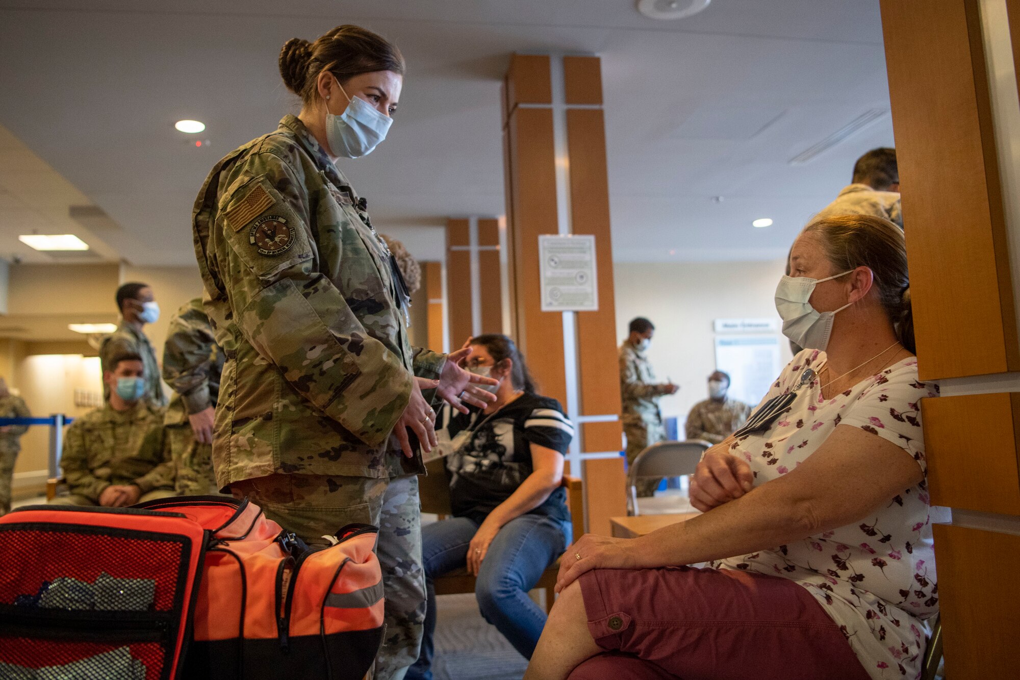 A woman interacts with a patient at the medical group.