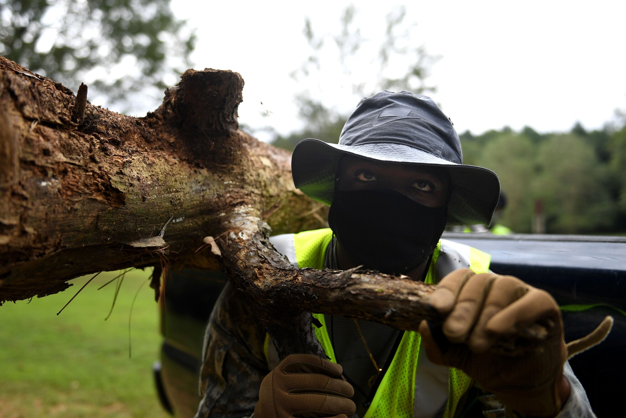 A person carries a log