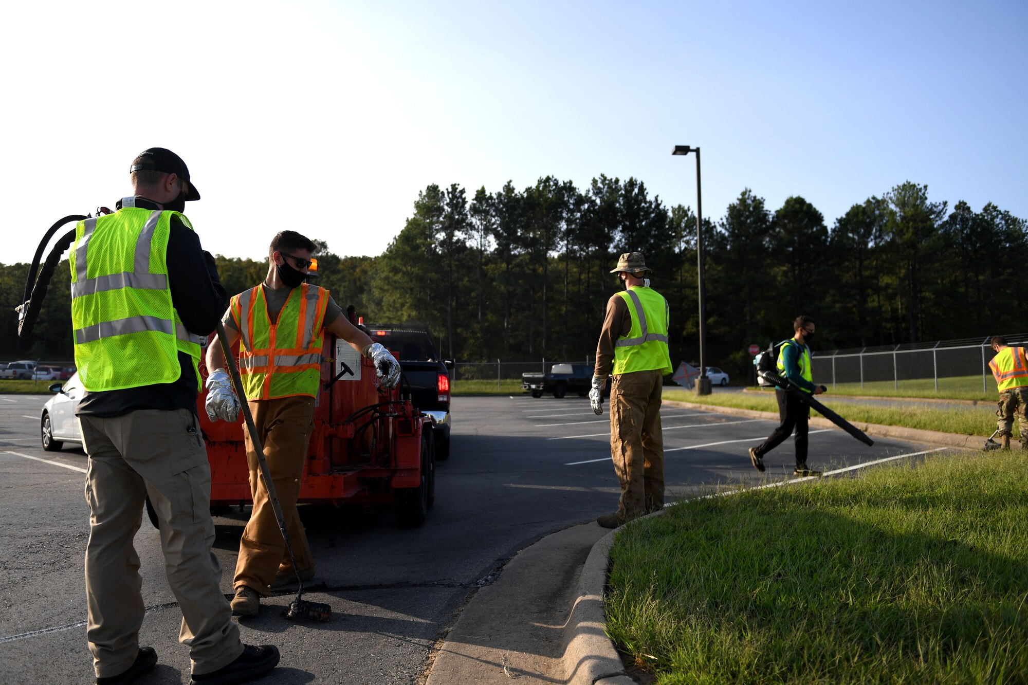 People clean up a parking lot