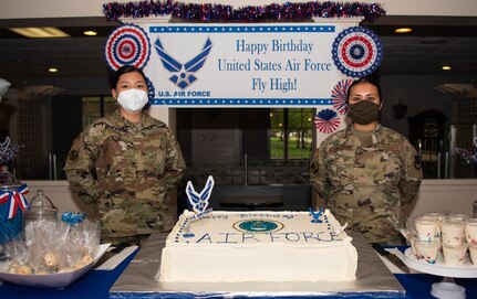 Airmen pose with a cake at Joint Base Langley-Eustis, Virginia.