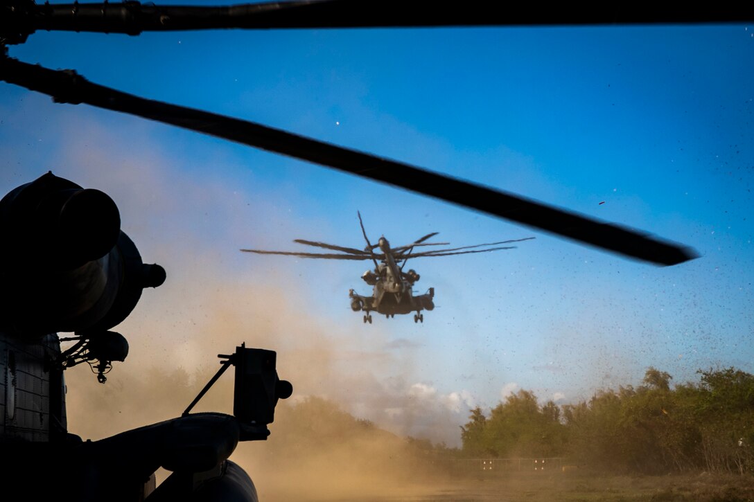 A U.S. Marine Corps CH-53E Super Stallion with Marine Heavy Helicopter Squadron 463 prepares to land during a convoy resupply aboard Marine Corps Training Area Bellows, July 29, 2020. HMH-463 and 1st Battalion, 12th Marine Regiment conducted convoy resupply training to support interoperability and demonstrate the capability of executing an expeditionary convoy resupply in austere environments. (U.S. Marine Corps photo by Lance Cpl. Jamie Shadwick)
