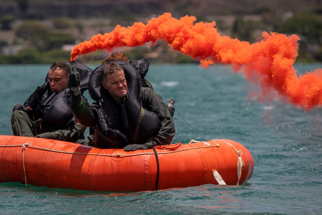 A U.S. Marine with Marine Medium Tiltrotor Squadron 363 ignites a smoke flair during a mishap drill, Marine Corps Base Hawaii, July 30, 2020. The purpose of the drill was to produce readiness for Marines with VMM-363 and 3rd Radio Reconnaisance in the event of a mishap. (U.S. Marine Corps photo by Cpl. Matthew Kirk)