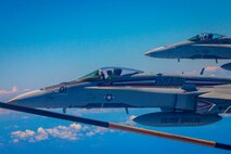 F/A-18 Hornets with Marine Fighter Attack Squadron 115 participate in an aerial refuel, Aug. 6, 2020. VMFA-115 and Marine Aerial Refueler Transport Squadron 152 conducted fixed wing aerial refueling in support of unit training, readiness, and proficiency. (U.S. Marine Corps photo by Cpl. Matthew Kirk)