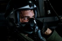 U.S. Marine Corps Sgt. James Edenfield, a crew chief assigned to Marine Medium Tiltrotor Squadron 363, observes the sky during Airborne Operations at the Lightning Academy, East Range Training Complex, Hawaii, Aug. 11, 2020. The training was conducted as part of the unit’s annual training requirements with 3rd Radio Battalion, VMM-363, Naval Special Warfare, and 25th Infantry Division to build proficiency and maintain insert capabilities. (U.S. Marine Corps photo by Lance Cpl. Samantha Sanchez)