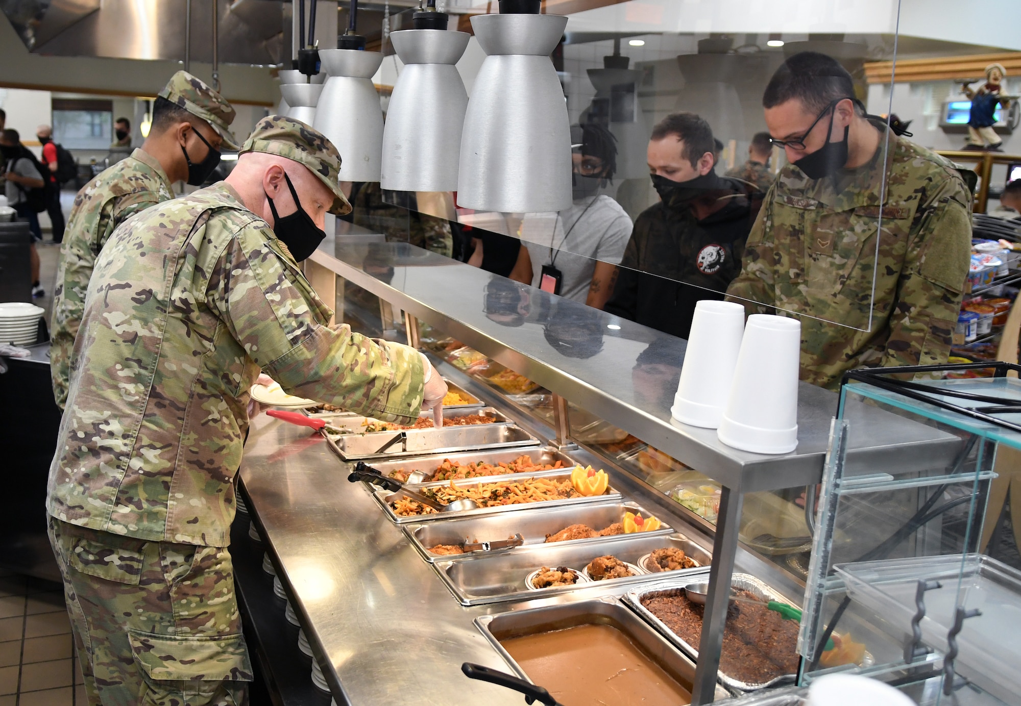 U.S. Air Force Lt. Col. Jeremy Sparks, 333rd Training Squadron commander, and Master Sgt. Byran Petry, 333rd TRS first sergeant, serve meals to Airmen inside the Azalea Dining Facility at Keesler Air Force Base, Mississippi, Sept. 18, 2020. As part of the Air Force's 73rd Birthday Celebration Week, Sept. 14-18, base leadership served meals to Airmen at the dining facilities. (U.S. Air Force photo by Kemberly Groue)