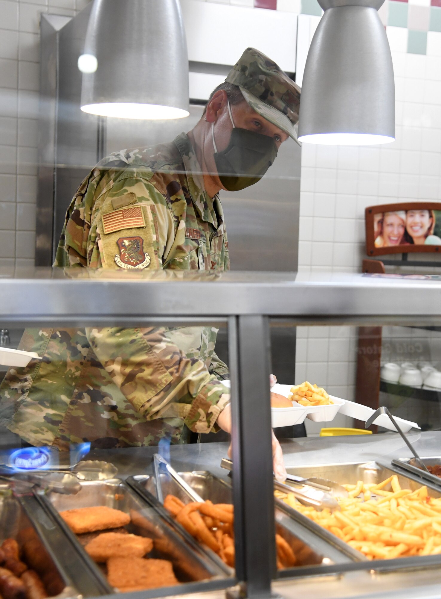 U.S. Air Force Col. James Kafer, 81st Training Wing vice commander, serves meals to Airmen inside the Azalea Dining Facility at Keesler Air Force Base, Mississippi, Sept. 18, 2020. As part of the Air Force's 73rd Birthday Celebration Week, Sept. 14-18, base leadership served meals to Airmen at the dining facilities. (U.S. Air Force photo by Kemberly Groue)