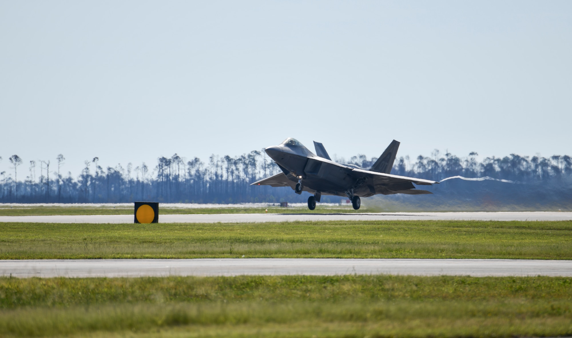 A U.S. Air Force F-22 Raptor Operational Test aircraft assigned to Nellis Air Force Base, Nevada, launches from the flight line at Tyndall Air Force Base, Florida, Sept. 18, 2020. The aircraft and aircrew participated in a Weapons System Evaluation Program held at Tyndall on behalf of Air Combat Command. (U.S. Air Force photo by Senior Airman Stefan Alvarez)