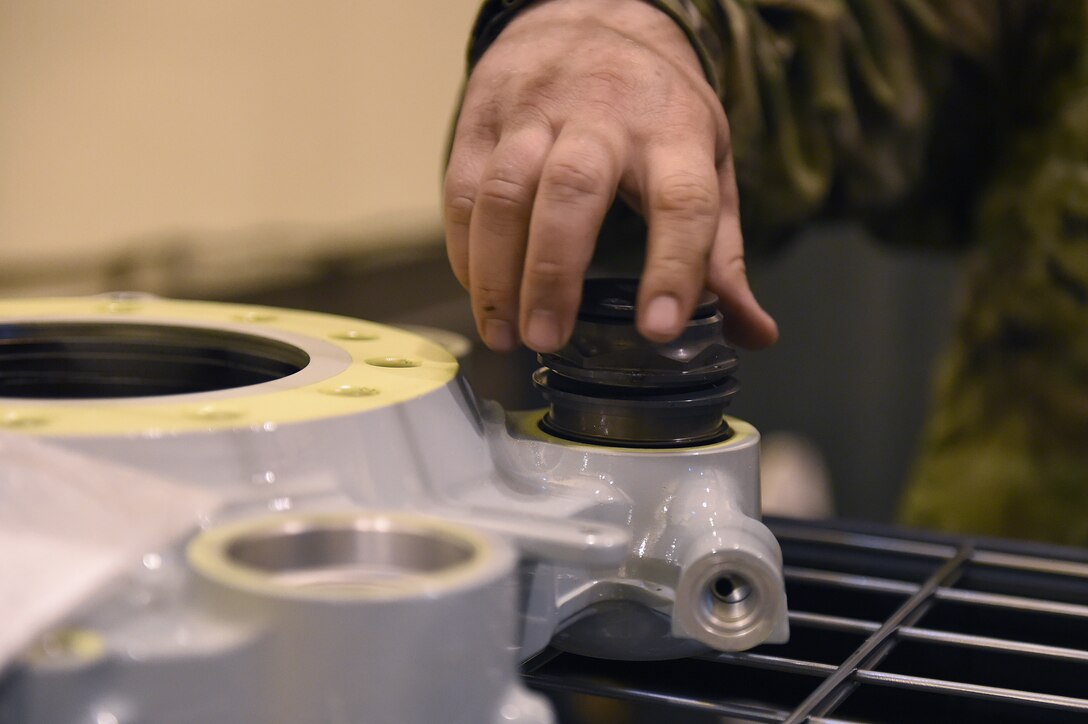 Staff Sgt. J.C. Hutchins, 62nd Maintenance Squadron aircraft hydraulic systems specialist, places a piston into a part of a C-17 Globemaster III hydraulic brake on Joint Base Lewis-McChord, Wash., Sept. 10, 2020. The brake system on a C-17 must be able to withstand 4,000 pounds per square inch of pressure. (U.S. Air Force photo by Airman 1st Class Mikayla Heineck)