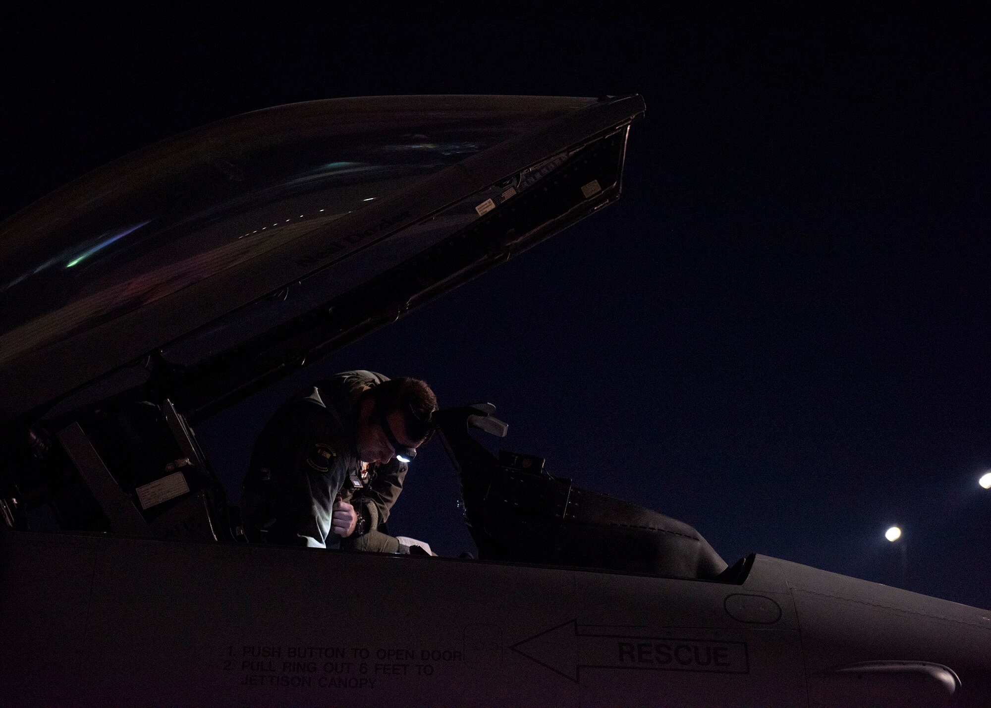 Pilot inspects aircraft on flight line.