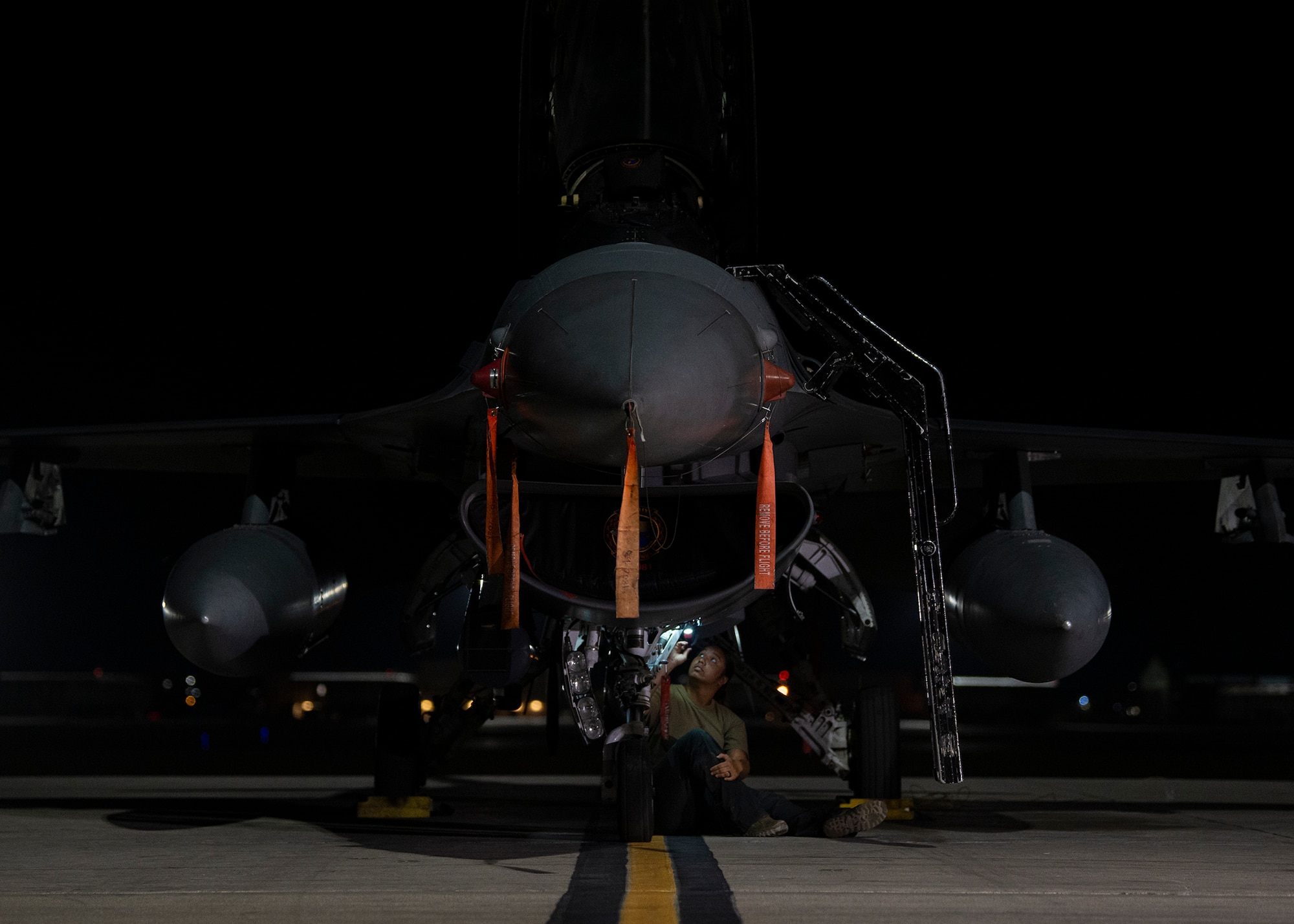 Airman inspects aircraft on the flight line.