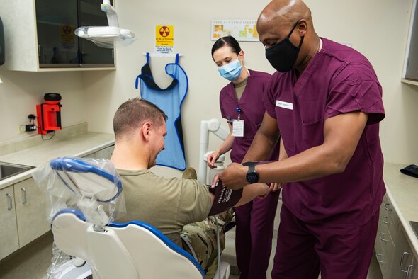 Chief Master Sgt. Ron Harper, 341st Missile Wing command chief, and Staff Sgt. Heather Cirilli, 341st Operational Medical Readiness Squadron dental technician, perform a dental exam on a patient Sept. 16, 2020, at Malmstrom Air Force Base, Mont.