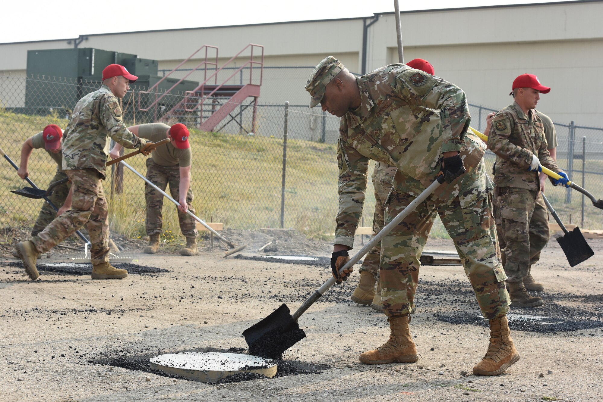 Chief Master Sgt. Ron Harper, 341st Missile Wing command chief, places cement with Airmen from the 819th RED HORSE Squadron and the 341st Civil Engineer Squadron Sept. 17, 2020, at Malmstrom Air Force Base, Mont.