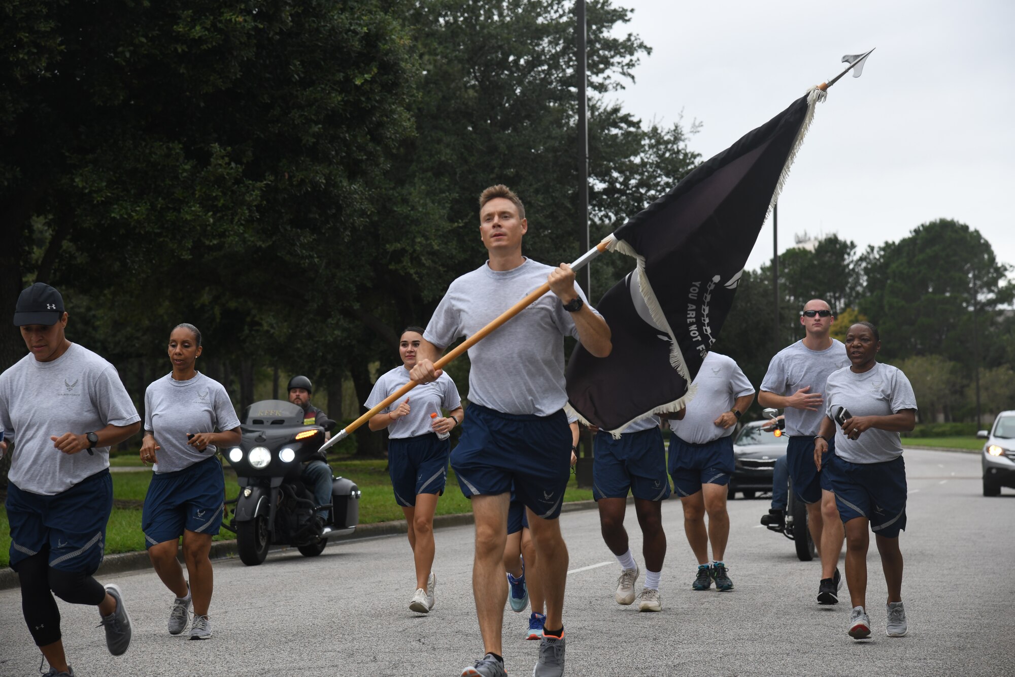 Airmen from the 628th Medical group runs with the POW/MIA flag Sept. 18, 2020, at Joint Base Charleston, S.C.