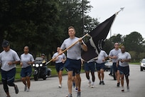 Airmen from the 628th Medical group runs with the POW/MIA flag Sept. 18, 2020, at Joint Base Charleston, S.C.