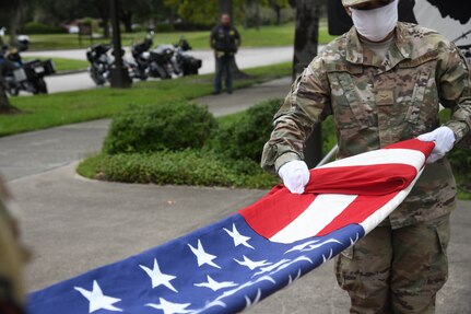 Airmen fold the POW/MIA flag Sept. 18, 2020, at Joint Base Charleston, S.C.