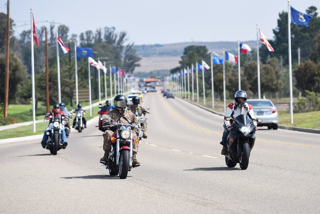 A motorcade makes their way to the Prisoner of War and Missing in Action Remembrance Ceremony Sept. 17, 2020, at Vandenberg Air Force Base, Calif. After the motorcade, Vandenberg AFB leadership gave speeches and a ceremonial presentation of the POW/ MIA flag. . Following the ceremony, members across the installation participated in a 24-hour walk or ruck while carrying the POW/ MIA flag, as well as a continuous 24-hour name reading of the past and current POW/MIA members, until the closing ceremony the next day. (U.S. Air Force photo by Senior Airman Hanah Abercrombie)