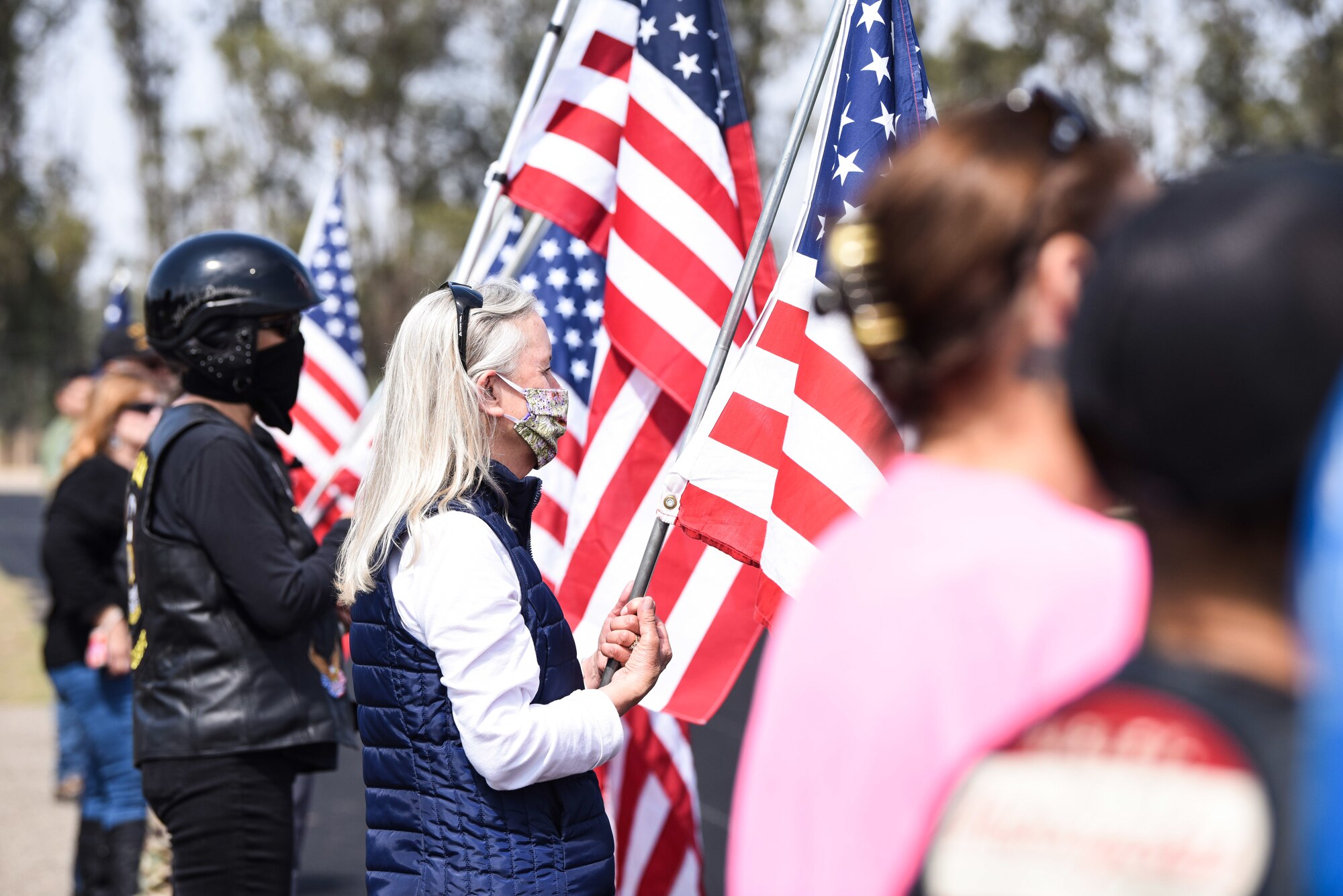 Members hold flags during the Prisoner of War and Missing in Action Remembrance Ceremony Sept. 17, 2020, at Vandenberg Air Force Base, Calif. Members from across base and the local community came together to remember and celebrate the lives of POW and MIA members. The first POW/MIA ceremony was held at the National Cathedral in Washington, D.C., after becoming an official recognition day in 1979. According to the Defense POW/MIA Accounting Agency, roughly 83,114 Americans from over five wars are missing in action, and 16,837 Americans died as prisoners of war. (U.S. Air Force photo by Senior Airman Hanah Abercrombie)