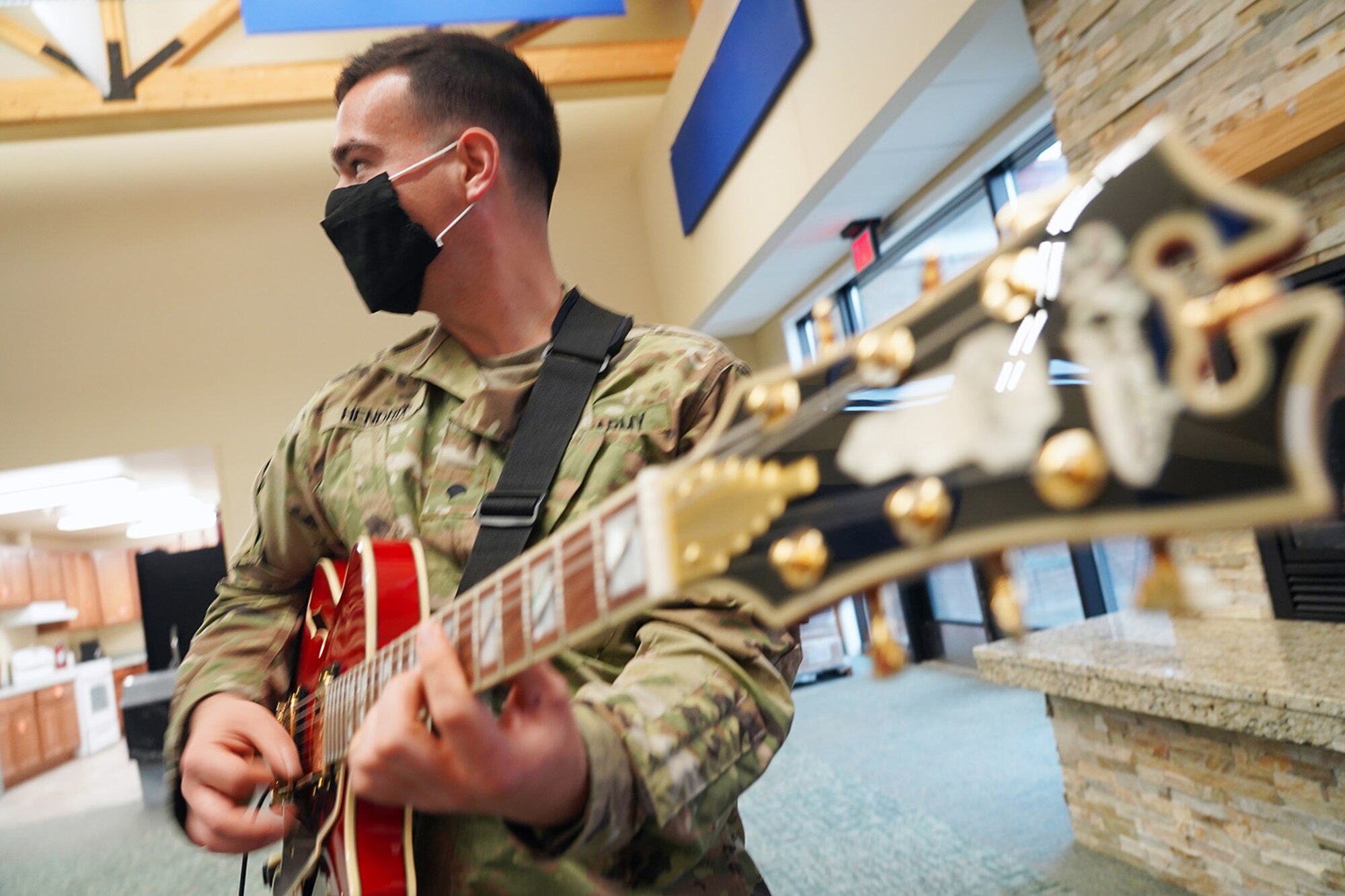 Army Spc. William Hendrix, a native of Greenville, SC, a guitarist assigned to the 9th Army Band, 17th Combat Sustainment Support Battalion, U.S. Army Alaska, rehearses in an open room at his unit headquarters on Joint Base Elmendorf-Richardson, Alaska, Sept. 17, 2020.