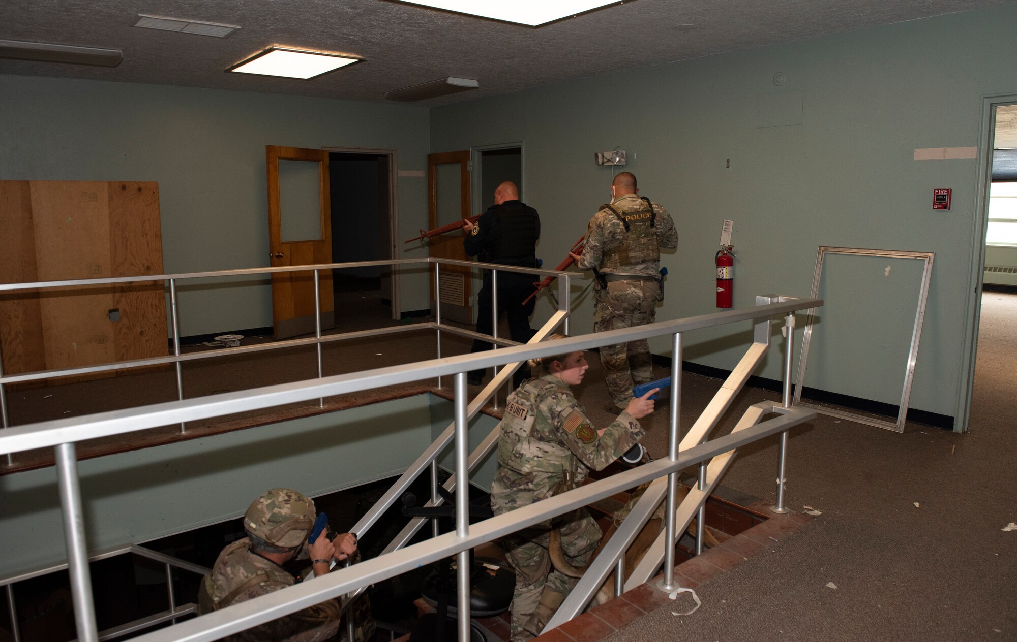 The Airman conducts a secondary sweep  as part of the active shooter exercise.