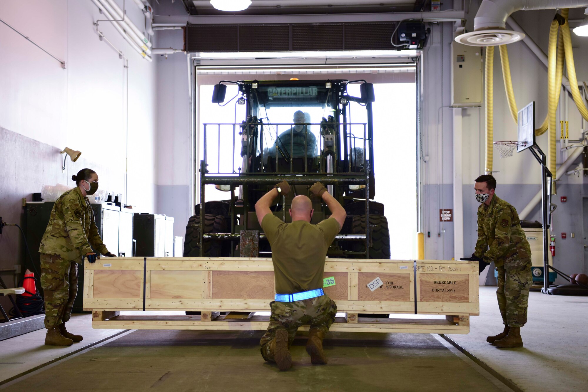 U.S. Air Force Airmen assigned to the 354th Logistics Readiness Squadron guide a forklift during Arctic Fox 20-2 on Eielson Air Force Base, Alaska, Sept. 15, 2020. Arctic Fox 20-2 is a five-day exercise aimed at helping the base prepare for F-35A deployments. (U.S. Air Force photo by Airman 1st Class Jose Miguel T. Tamondong)
