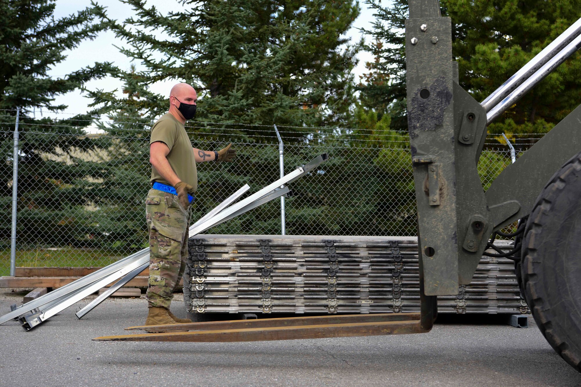 U.S. Air Force Staff Sgt. Jordan Ackley, the 354th Logistics Readiness Squadron noncommissioned officer in charge of the cargo deployment function, guides a forklift during Arctic Fox 20-2 on Eielson Air Force Base, Alaska, Sept. 15, 2020. The objective of the exercise is to test the unit’s capabilities to deploy 11 chalks of aircraft cargo over the course of five days. (U.S. Air Force photo by Airman 1st Class Jose Miguel T. Tamondong)