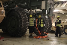 Contractors secure this piece of heavy equipment at the Port of Shuiaba, Kuwait, September 11, 2020. The 1184th Deployment and Distribution Support Battalion, from Mobile, AL is responsible for the movement of nearly 400 pieces from several different units on this shipment. (U.S. Army Reserve Photo By Sgt. Vontrae Hampton)