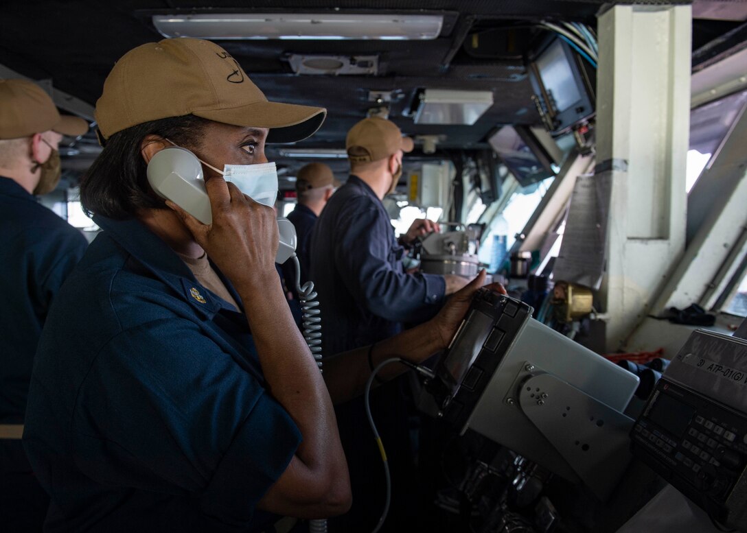 200918-N-DQ752-1020 STRAIT OF HORMUZ (Sept. 18, 2020) Chief Hospital Corpsman Debra Pee conducts communications from the bridge of the aircraft carrier USS Nimitz (CVN 68) during a Strait of Hormuz transit, Sept. 18. Nimitz Carrier Strike Group is deployed to the U.S. 5th Fleet area of operations in support of naval operations to ensure maritime stability and security in the Central Region, connecting the Mediterranean and the Pacific through the western Indian Ocean and three strategic choke points. With Nimitz as the flagship, deployed strike group assets include staffs, ships and aircraft of Carrier Strike Group 11, Destroyer Squadron 9, USS Princeton (CG 59) and Carrier Air Wing 17. (U.S. Navy photo by Mass Communication Specialist 3rd Class Cheyenne Geletka)