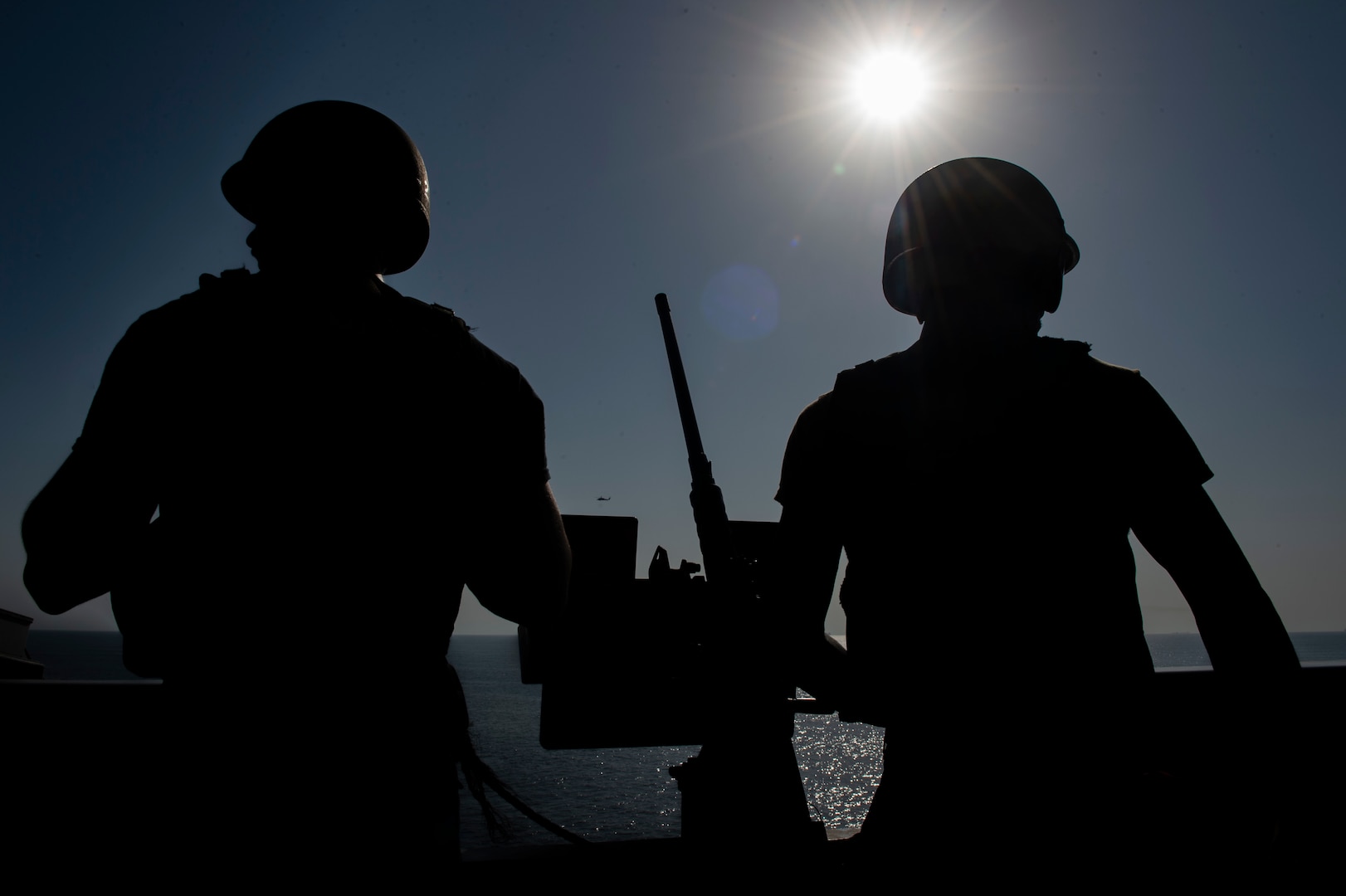 200915-N-DQ752-1071 STRAIT OF HORMUZ (Sept. 18, 2020) Sailors man a .50-caliber machine gun mount on the flight deck of the aircraft carrier USS Nimitz (CVN 68) during a Strait of Hormuz transit, Sept. 18. Nimitz Carrier Strike Group is deployed to the U.S. 5th Fleet area of operations in support of naval operations to ensure maritime stability and security in the Central Region, connecting the Mediterranean and the Pacific through the western Indian Ocean and three strategic choke points. With Nimitz as the flagship, deployed strike group assets include staffs, ships and aircraft of Carrier Strike Group 11, Destroyer Squadron 9, USS Princeton (CG 59) and Carrier Air Wing 17.  (U.S. Navy photo by Mass Communication Specialist 3rd Class Cheyenne Geletka)