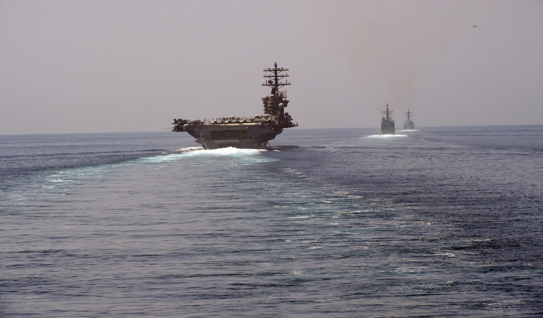200918-N-IE405-1060 STRAIT OF HORMUZ (Sep. 18, 2020) The aircraft carrier USS Nimitz (CVN 68), guided-missile cruiser USS Princeton (CG 59) and guided-missile destroyer USS Sterett (DDG 104) steam in formation during a Strait of Hormuz transit, Sept. 18. The Nimitz Carrier Strike Group is deployed to the U.S. 5th Fleet area of operations in support of naval operations to ensure maritime stability and security in the Central Region, connecting the Mediterranean and the Pacific through the western Indian Ocean and three strategic chokepoints. (U.S. Navy photo by Mass Communication Specialist 2nd Class Indra Beaufort)