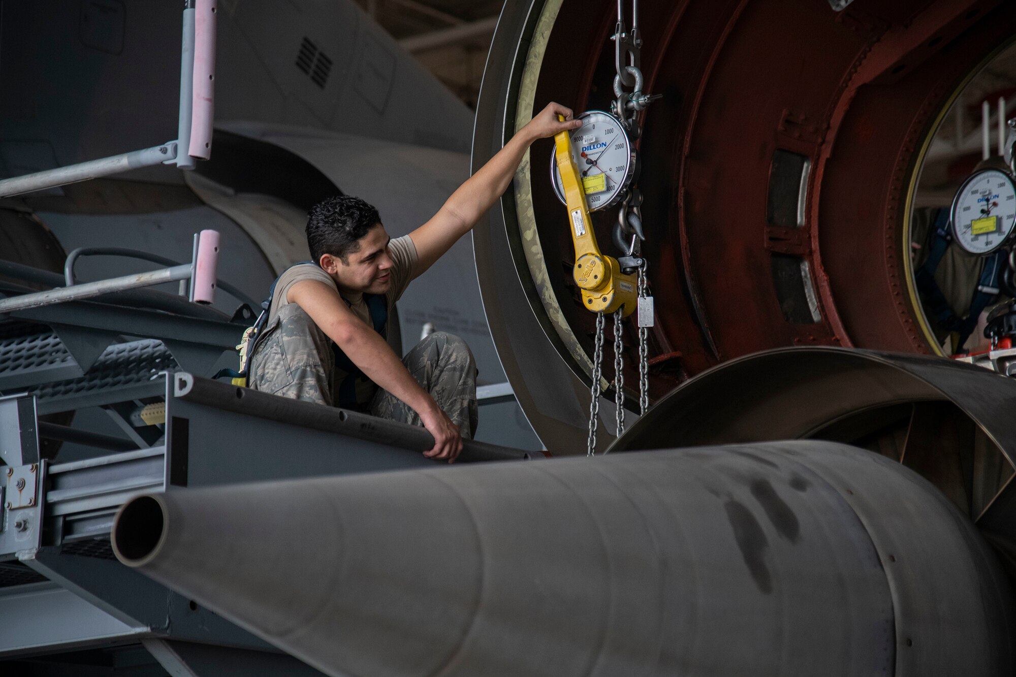 Airman 1st Class Gabriel Gonzalez, 60th Aircraft Maintenance Squadron aerospace propulsion journeyman, checks gauges to verify weight load during a C-5M Super Galaxy engine change September 9, 2020, at Dover Air Force Base, Delaware. Weighing between five to six tons and costing 15.5 million dollars, C-5M engines are handled with precision and care. (U.S. Air Force photo by Airman 1st Class Jonathan Harding)