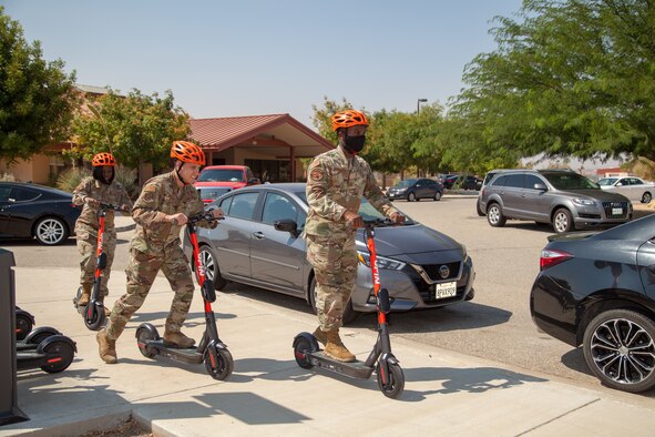 Team Edwards personnel demonstrate the new Spin scooters near the Airmen dormitories at Edwards Air Force Base, California, during the projects launch Sept. 2. (Air Force photo by Ethan Wagner)