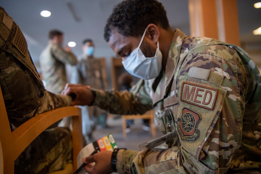 An Airman checks on a patient in the medical facility.
