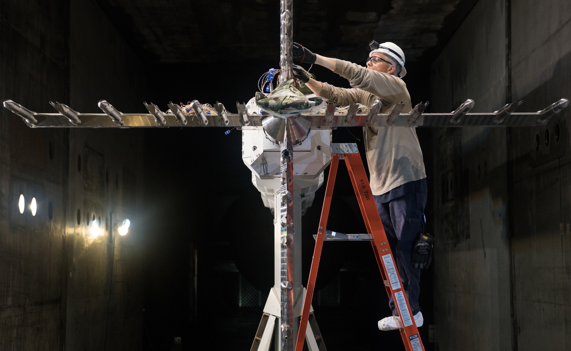 Ashley Dement, an electrical technician lead, works on a rake used to characterize the flow of the Arnold Engineering Development Complex 16-foot Supersonic Wind Tunnel, March 24, 2020, at Arnold Air Force Base, Tenn. (U.S. Air Force photo by Jill Pickett)