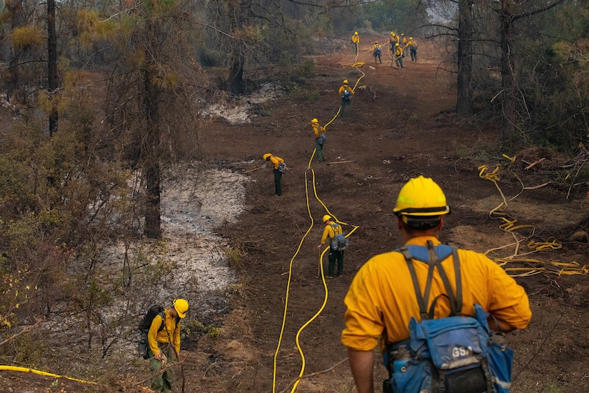 Soldiers with Alpha Battery, 2nd Battalion, 17th Field Artillery Regiment, attached to the 14th Brigade Engineer Battalion, extend a hose line.