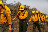 Soldiers with Alpha Battery, 2nd Battalion, 17th Field Artillery Regiment, attached to the 14th Brigade Engineer Battalion, hike up a mountain carrying hoses and equipment to plume the fireline, in order to cool down hotspots, at the August Complex wildland fire Sept. 13, 2020, in Mendocino National Forest.