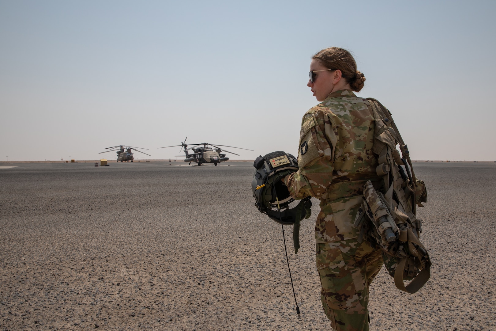 U.S. Army Sgt. Kayla Sampson walks out to a UH-60 Black Hawk July 30, 2020, to perform the daily pre-flight checks required for every MEDECAV aircraft to ensure they are ready to take flight at a moments notice. Sampson is deployed to Camp Buehring, Kuwait with Charlie Company, 2-238th General Aviation Support Battalion, and as a flight medic performing all in-flight medical attention to patients during transport. (U.S. Army photo by Sgt. Sydney Mariette)